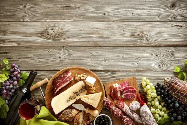 Romantic dinner with wine, cheese and traditional sausages — Stock Photo, Image