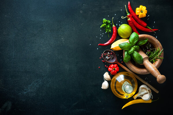 Herbs and spices on slate background