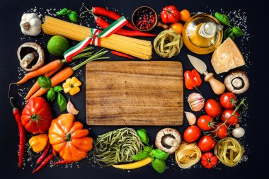 Italian food ingredients on slate background clipart