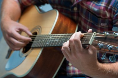 musician playing acoustic guitar clipart