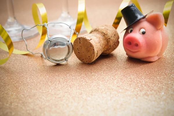 Lucky pig and cork from champagne bottle — Stock Photo, Image