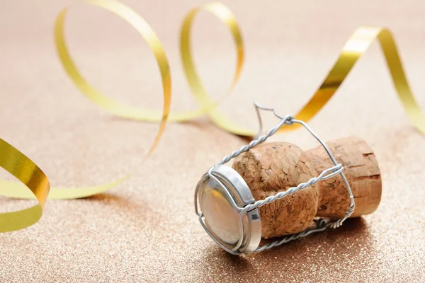 Cork from champagne bottle with streamers — Stock Photo, Image