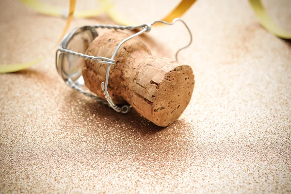 Cork from champagne bottle with streamers — Stock Photo, Image