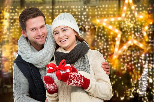 Happy young couple with Christmas present — Stock Photo, Image