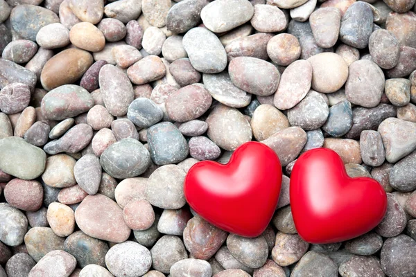 Dois corações vermelhos em pedras de seixo — Fotografia de Stock