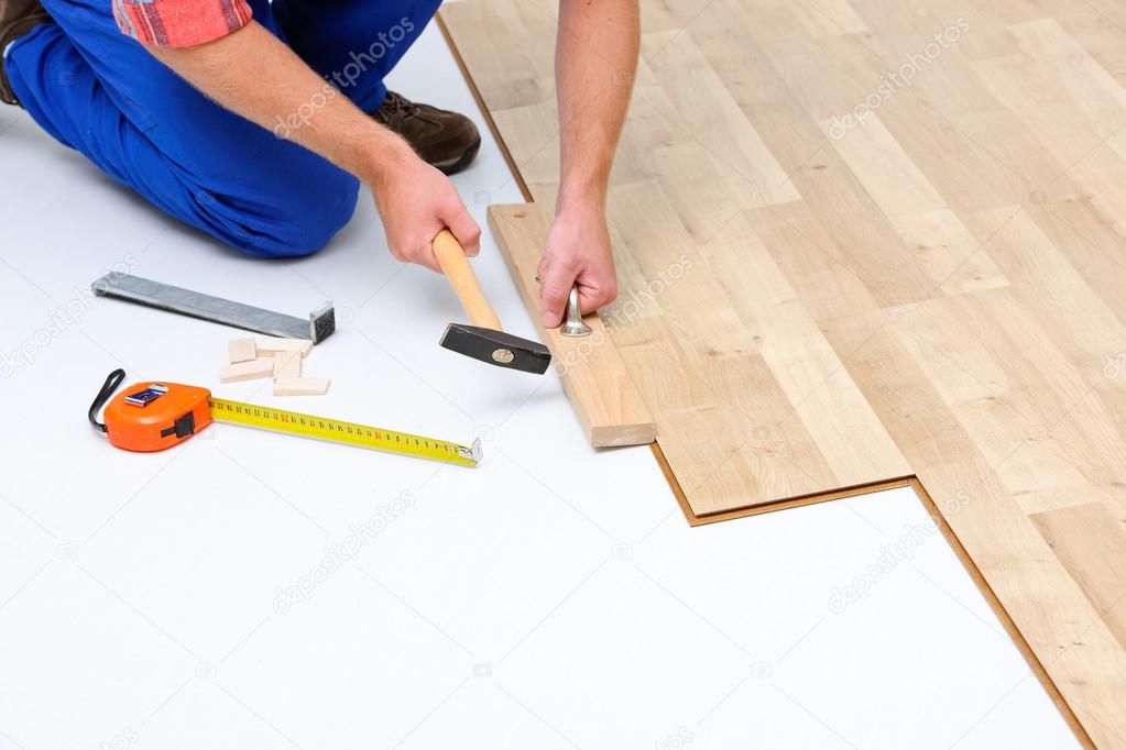 Man laying laminate flooring