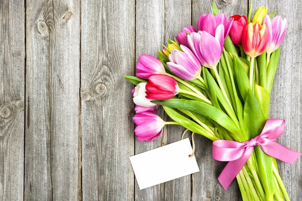 空のタグと春のチューリップの花束 — ストック写真