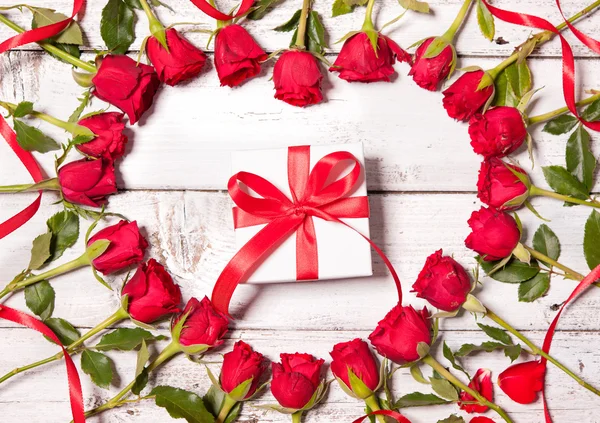 Cornice di rose fresche con una confezione regalo — Foto Stock