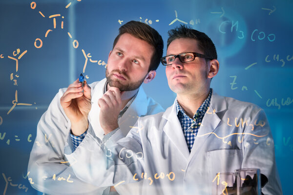 Group of scientists working at media screen