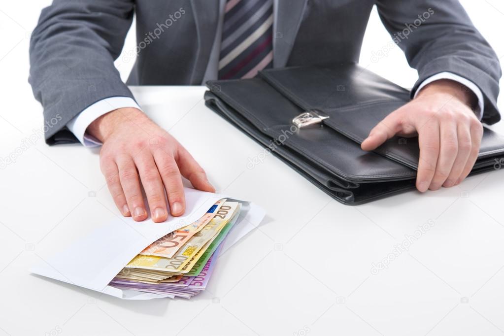 Businessman in a suit takes a bribe