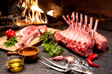 Rack of lamb in front of a fireplace clipart