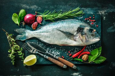 Fresh Gilt-head bream with spices and seasoning clipart
