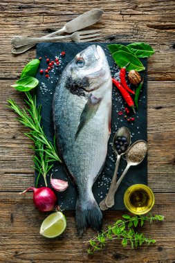 Fresh Gilt-head bream with spices and seasoning clipart