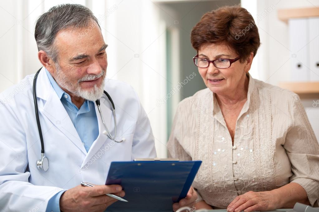 Doctor talking to his female senior patient