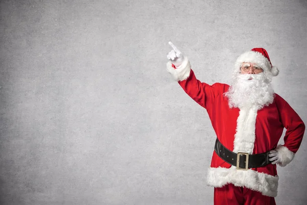 Santa Claus wskazując na ścianie — Zdjęcie stockowe