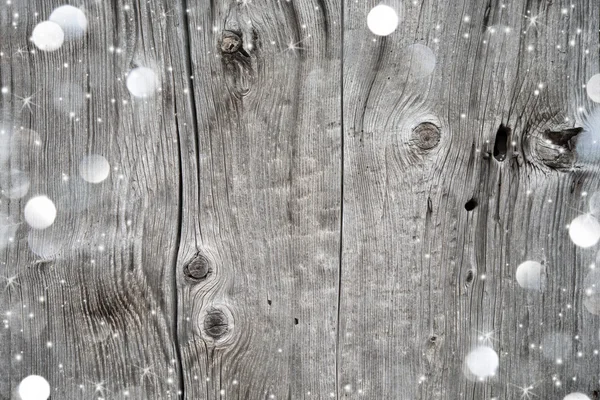 Fondo de Navidad con nieve y luces en madera — Foto de Stock