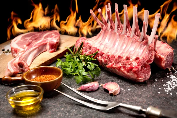 Rack of lamb in front of a fireplace — Stock Photo, Image