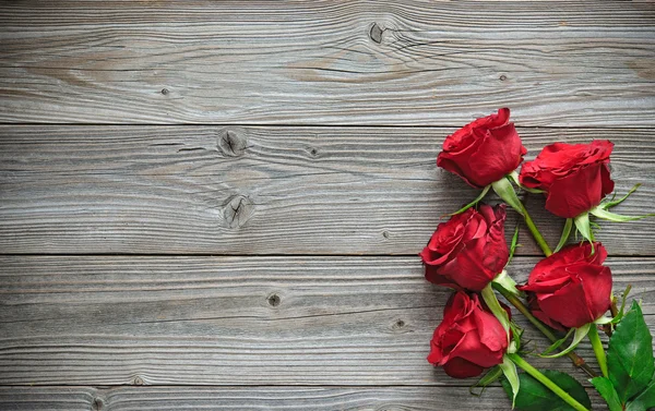Red roses on wooden board Royalty Free Stock Images