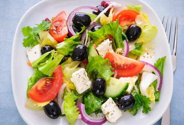 Greek salad isolated on white