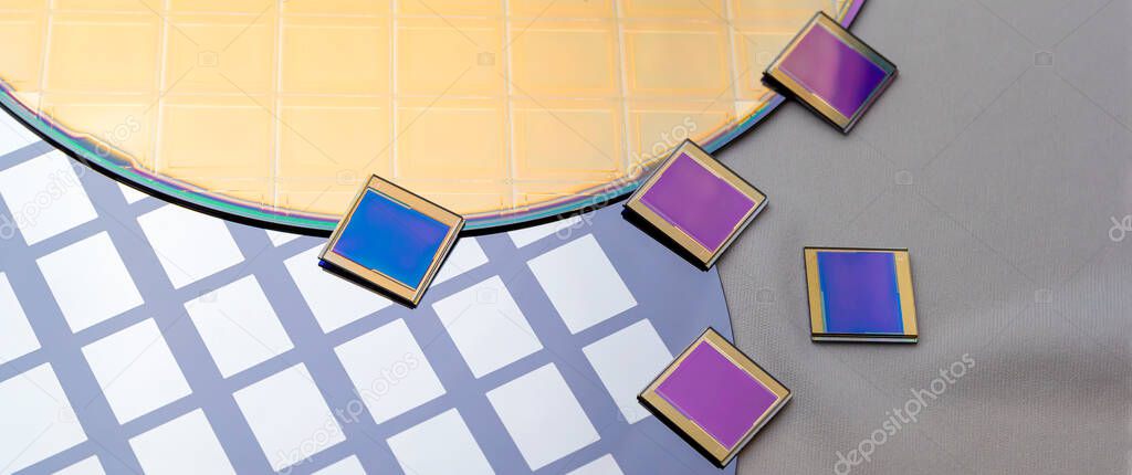 Several silicon wafers with printed circuit and separate microchips .