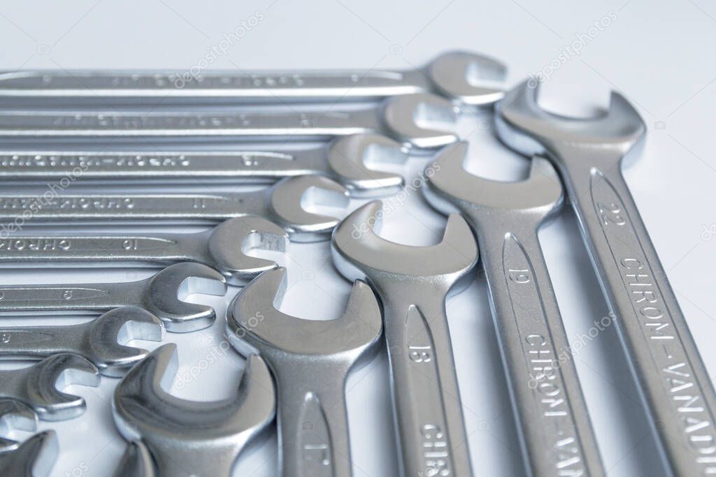 Cut-out wrenches horizontally placed from the biggest to the smallest in a row. Top view composition. Hand tool. Tools for carpentry work.