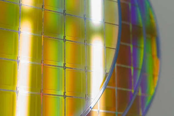 Silicon Wafers with microchips - A wafer is a thin slice of semiconductor material, such as a crystalline silicon, used in electronics for the fabrication of integrated circuits.Several pieces of wafers with microchips.