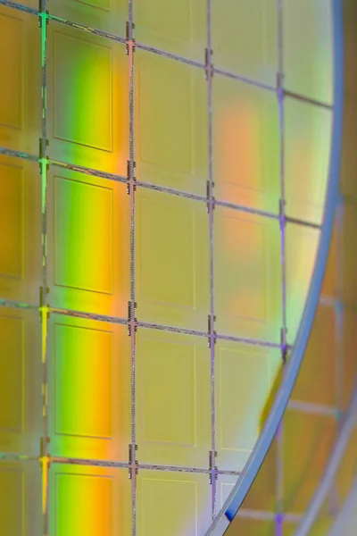 Silicon Wafers with microchips - A wafer is a thin slice of semiconductor material, such as a crystalline silicon, used in electronics for the fabrication of integrated circuits.Several pieces of wafers with microchips.