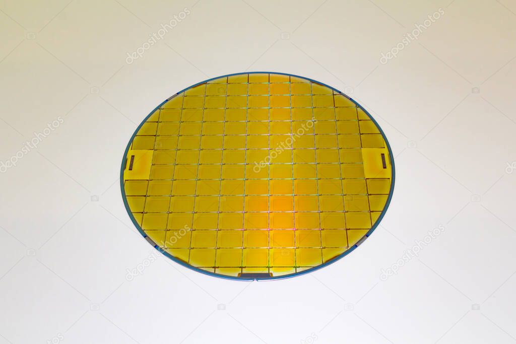 Silicon Wafer with microchip yellow color, backside is grey color - A wafer is a thin slice of semiconductor material, such as a crystalline silicon, .Wafer with microchips.Rainbow on silicon wafer.Color silicon wafers with glare.