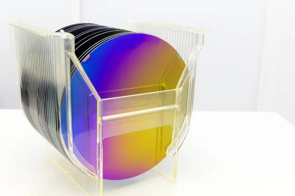 Silicon Wafers in plastic storage box in clear room of semiconductor foundry. Stock Image