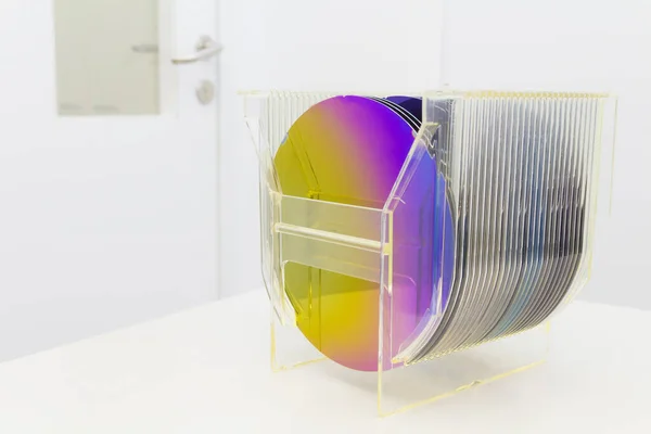 Silicon Wafers in plastic storage box in clear room of semiconductor foundry. Royalty Free Stock Photos