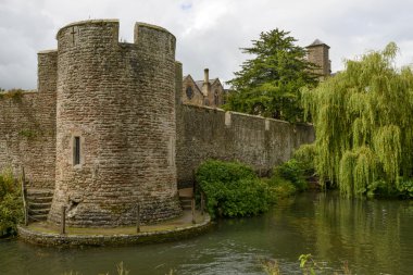 round tower and willow tree on moat at Bishop palace ,Wells clipart