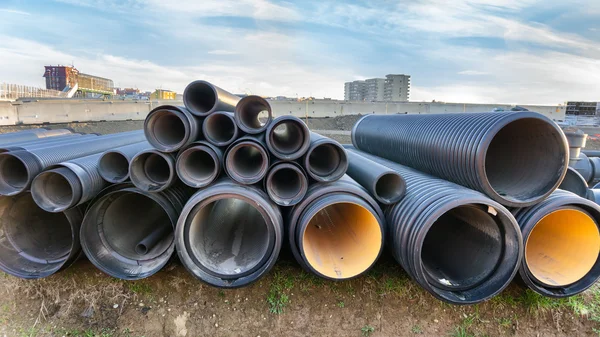 Stacked pipes in construction site — Stock Photo, Image