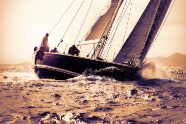 sail boat sailing on sunset clipart
