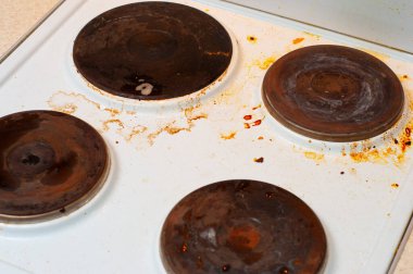 Paslı krep ve portakal yağı lekeli eski kirli mutfak sobası.