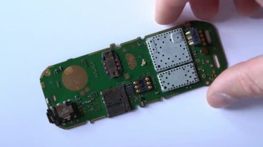 Kiev, Ukrayna - 11 Mart 2021: Eski telefonun elektronik panosu beyaz bir arkaplana yerleştirilir ve ters çevrilir