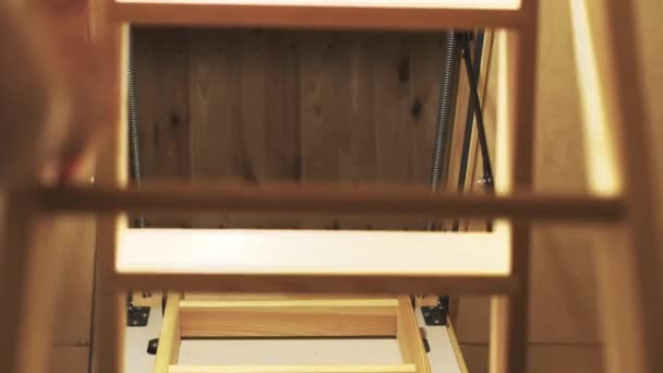 Folding the wooden loft staircase into the ceiling — Vídeo de Stock