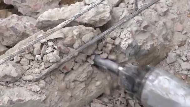 Sloop van een drilboor van een betonnen constructie op een bouwplaats close-up, bovenaanzicht — Stockvideo