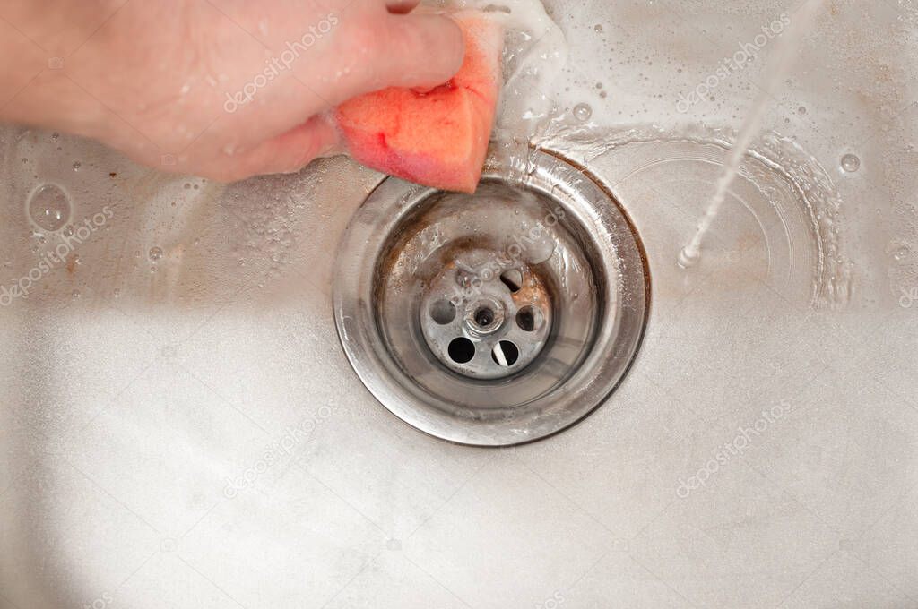 A clear example of the action of a high-quality detergent using the example of a kitchen sink drain. Rubbing with a sponge