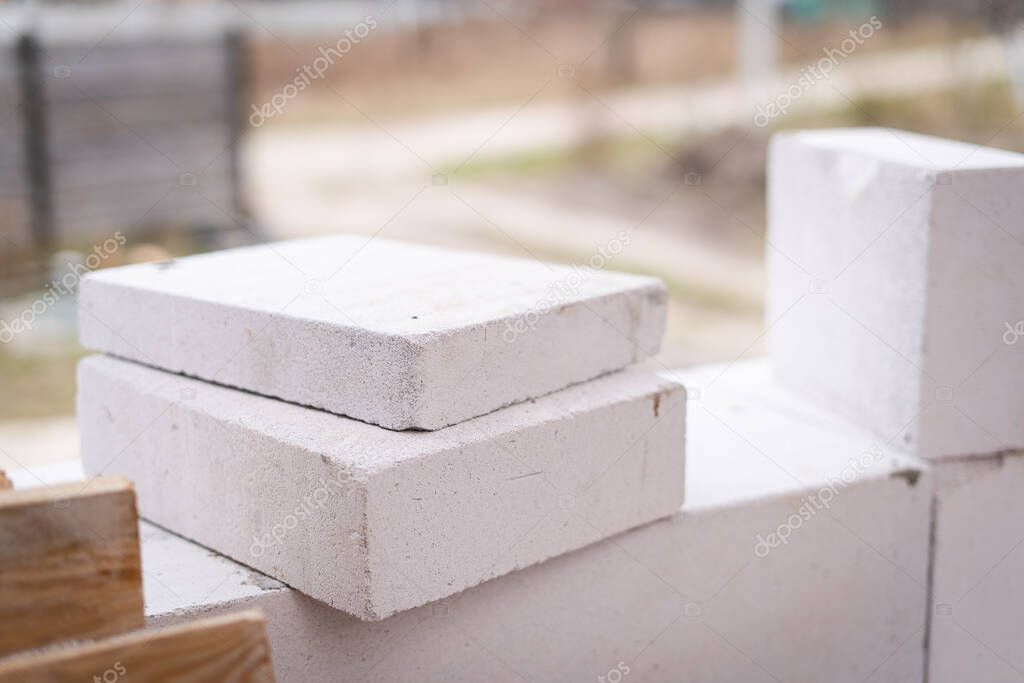 Cut-to-size aerated concrete blocks lie at the construction site