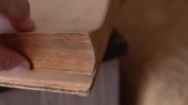Fast flipping of an old book close-up in slow motion