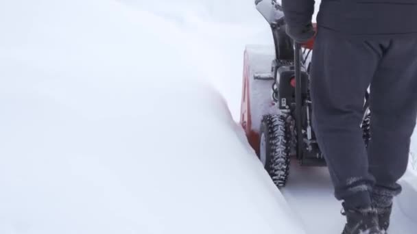 Kiev, Ukraine - February 14, 2021: Forte gasoline-powered snowblower makes a trail in a large layer of snow. Snow removal with special equipment — Stock Video