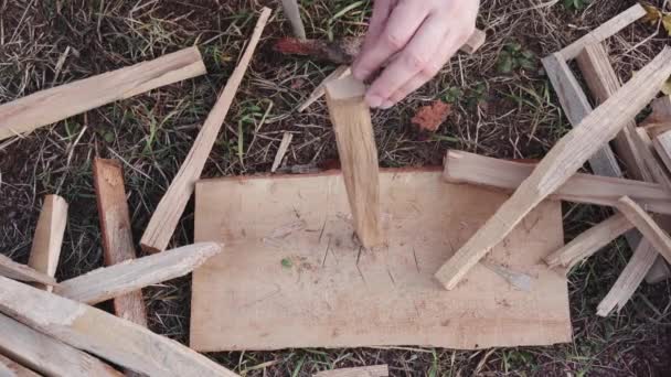 Preparing firewood for lighting a fire outside — Stock Video