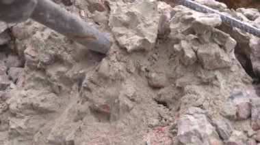 Destruction of a concrete wall with a pneumatic hammer close-up
