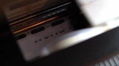 Printer prints the words World News on white glossy paper