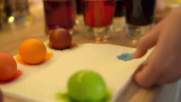 A painted blue Easter egg is placed on a napkin to dry — Stockvideo