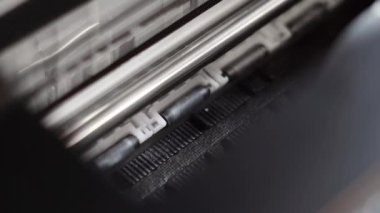 Printer prints on white glossy paper close-up