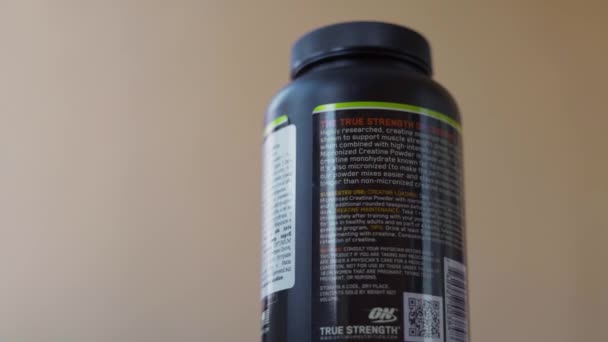 Kiev, Ukraine - June 16,2021: Can of optimum nutrition micronized creatine powder spinning in close-up — Stock Video