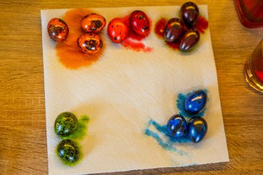 Taze boyanmış yeşil, mavi, kırmızı ve turuncu bıldırcın yumurtaları mutfakta yatıyor.