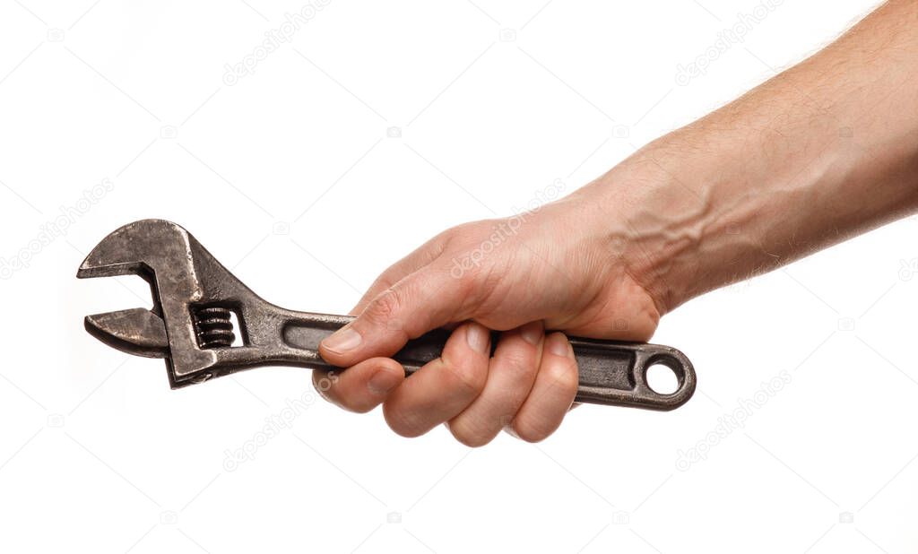 Adjustable wrench in the hands of a man on a white background isolate and close-up