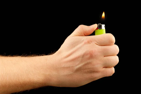 Lighter in hand on a black background